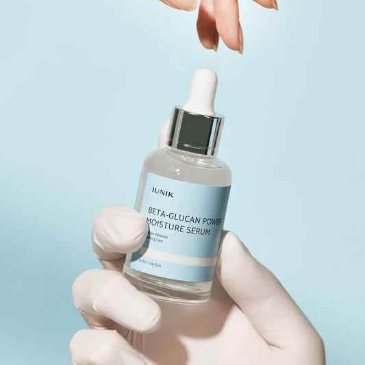 A clear glass bottle with silver dropper cap and light blue label holding iunik beta glucan power moisture serum for skin by best korean skincare brands sa