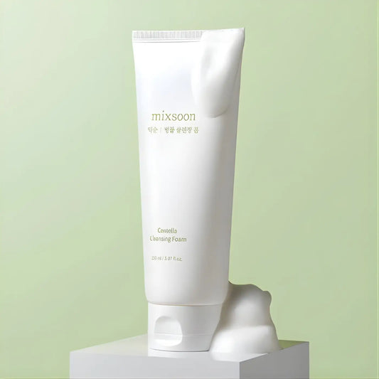 White tube of mixsoon centella cleansing foam 150ml with minimalist gold lettering and soft frothy centella cleansing texture spilling