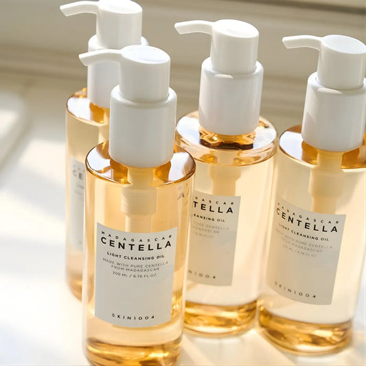 Clear glass bottles with white pumps of golden madagascar centella light cleansing oil by skin1004 best korean skincare brands sa