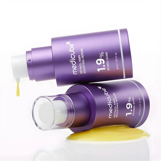 Two purple medicube retinol nmn boosting serum bottles 1.9 percent retinol for improving skin texture