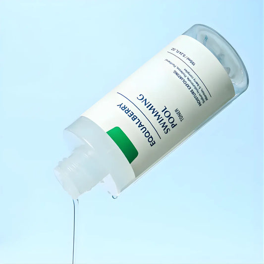 A clear glass equalberry swimming pool moisture exfoliating toner bottle with white label and green accent for skin care