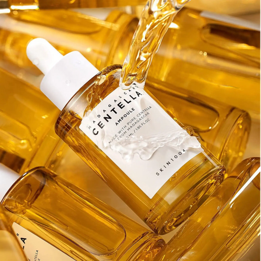 A clear glass bottle of golden-yellow madagascar centella ampoule serum by skin1004 for k-beauty south africa skincare