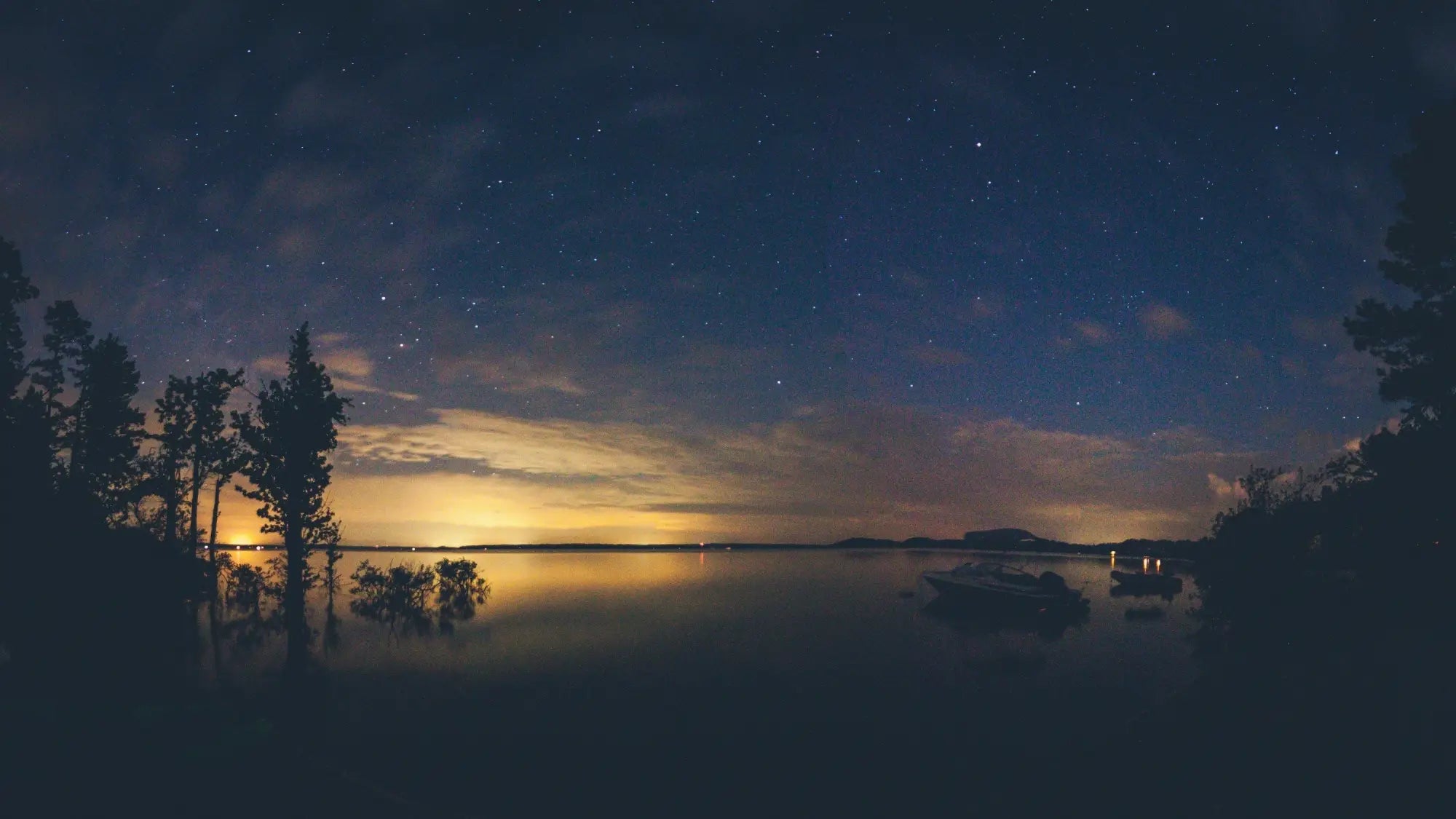 A serene night sky above a tranquil lake reflecting sunset hues illustrating perfect timing for k-beauty south africa routine