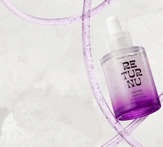 A clear glass bottle with white dropper cap containing gradient purple liquid in authentic korean skincare south africa guide