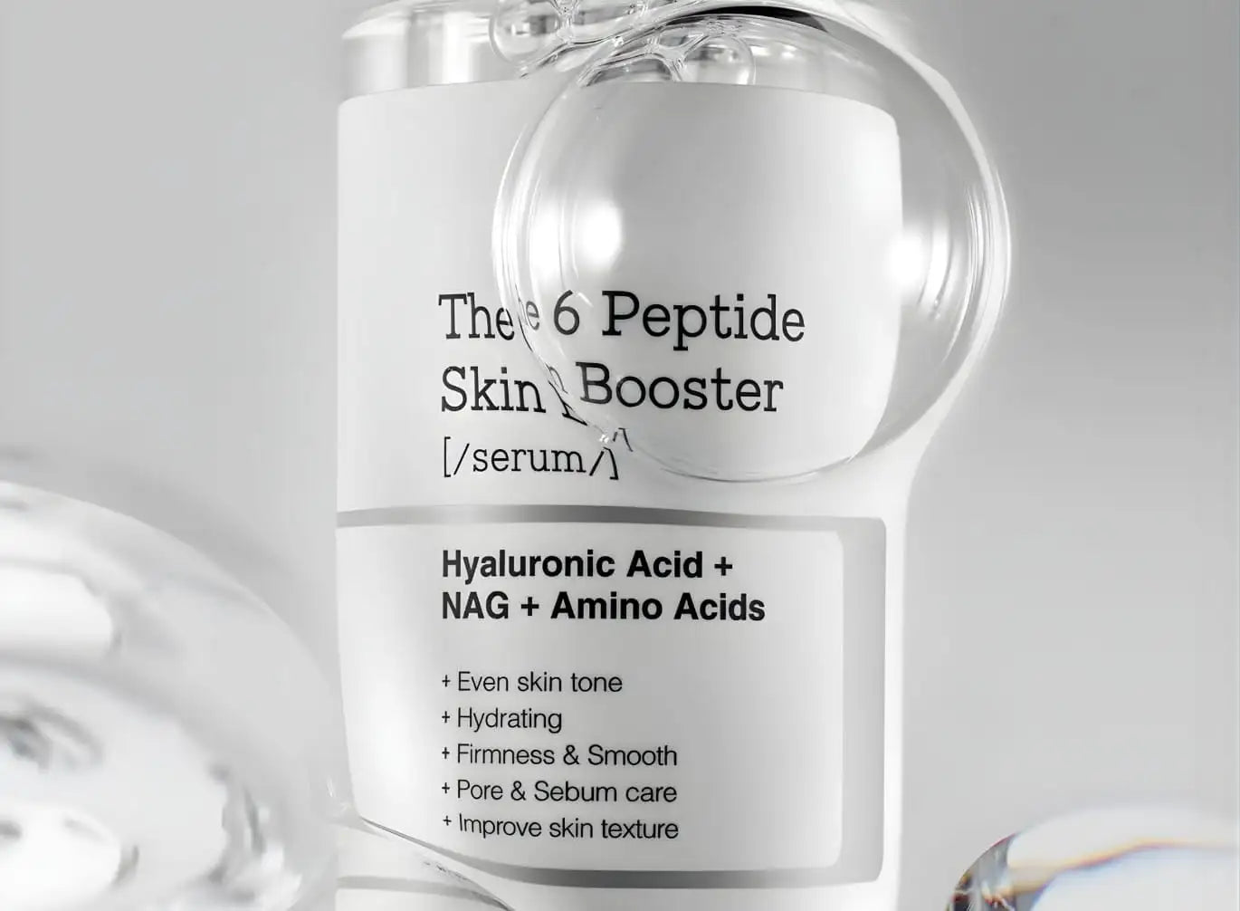 Clear glass bottle with a white label featuring black text that reads ’the 6 peptide skin booster’ and lists ingredients like hyaluronic acid, nag, and amino acids.