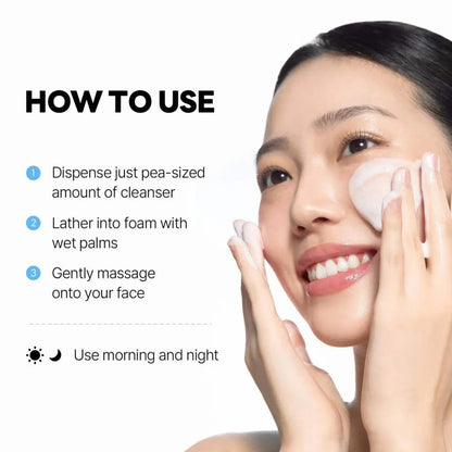 A soft white oval facial cleanser sponge gently used on a woman’s cheek with dokdo cleanser from the seoul palette