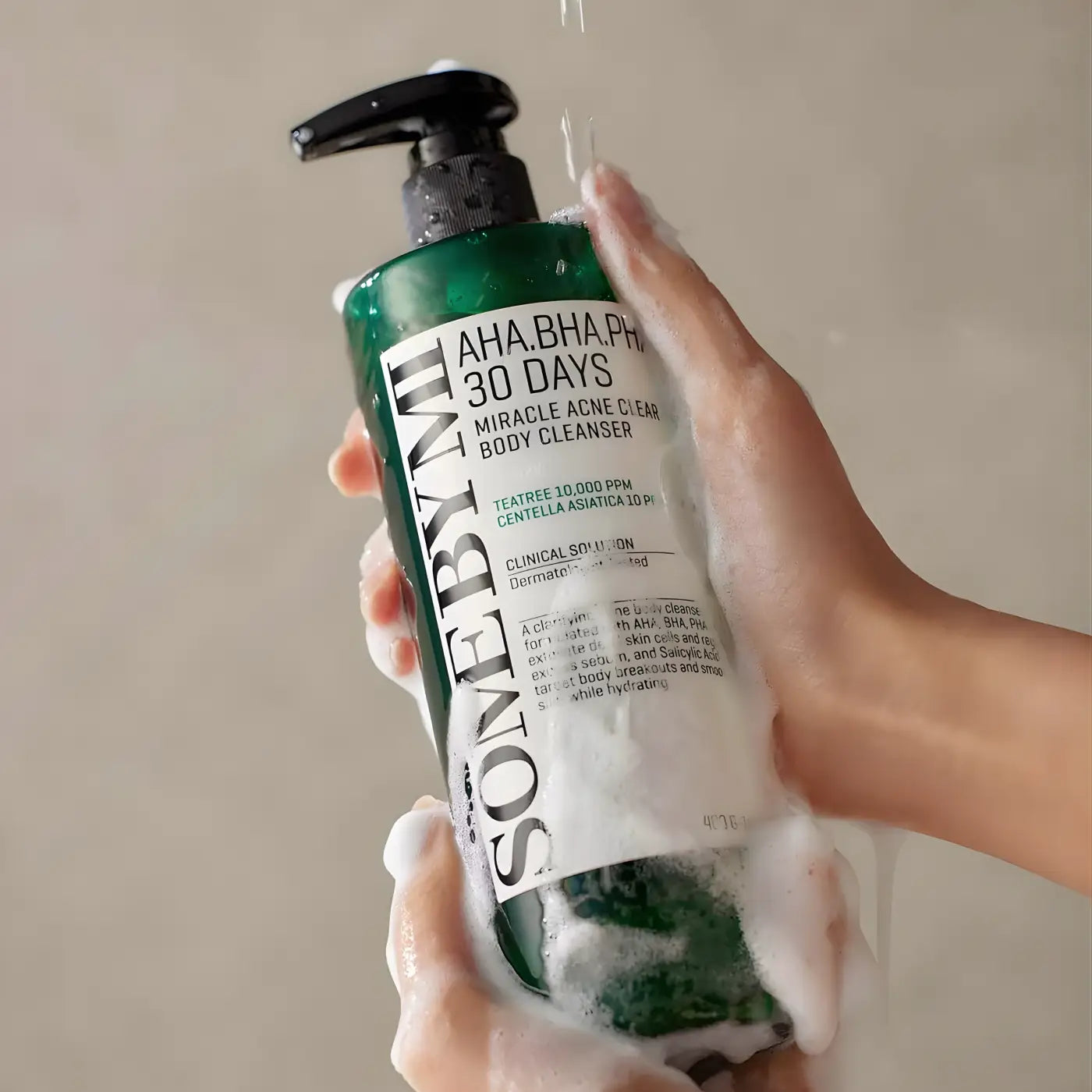 Green bottle of some by mi aha bha pha 30 days miracle acne clear body cleanser with black pump and white label