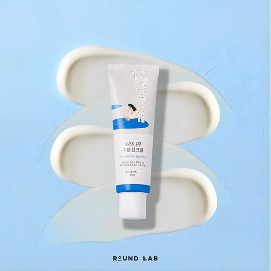 A white and blue tube of birch juice moisturizing sunscreen spf50 plus pa++++ with a cartoon illustration on the label