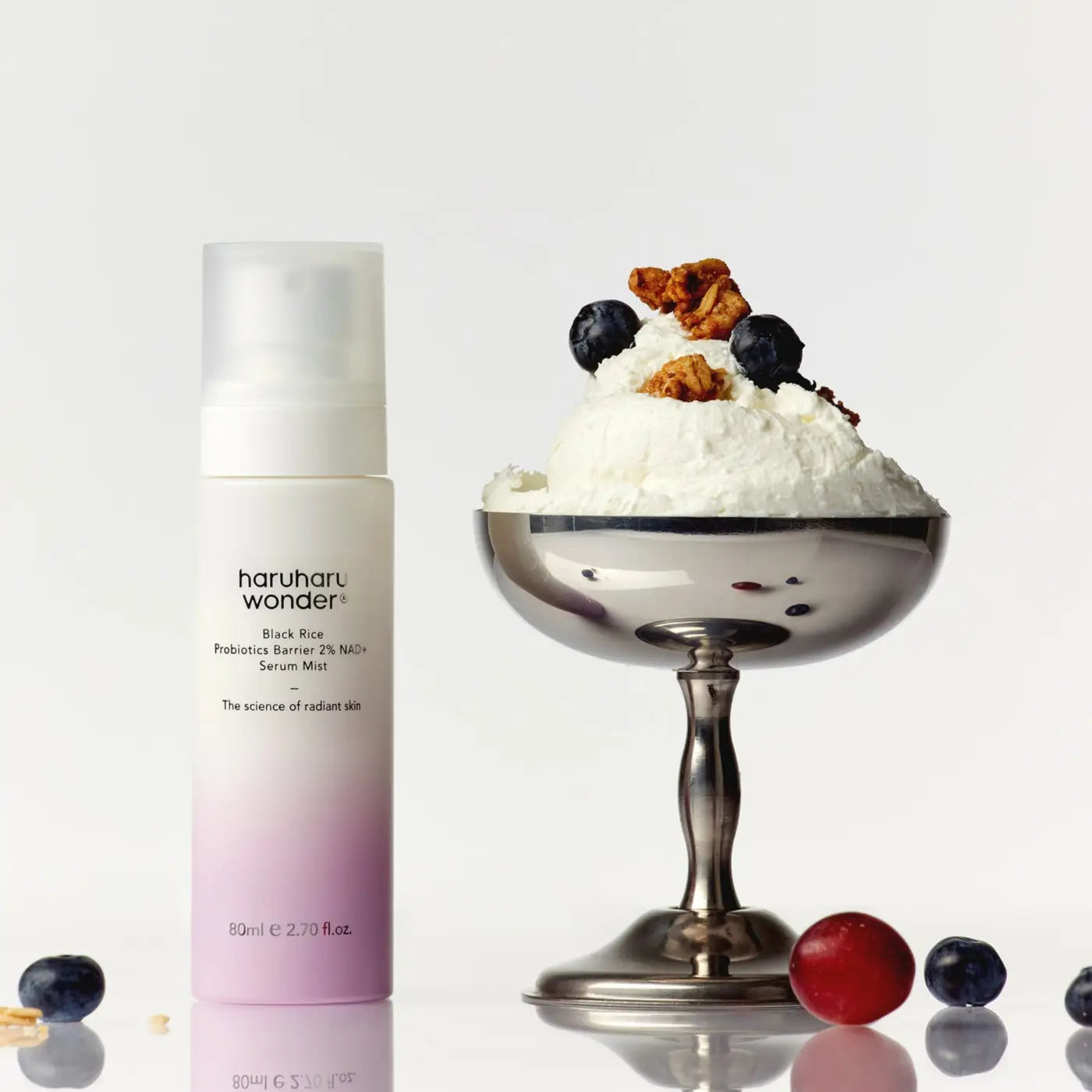 An 80ml frosted glass bottle of haruharu wonder black rice probiotics barrier 2% nad serum mist with pink gradient label and white pump dispenser