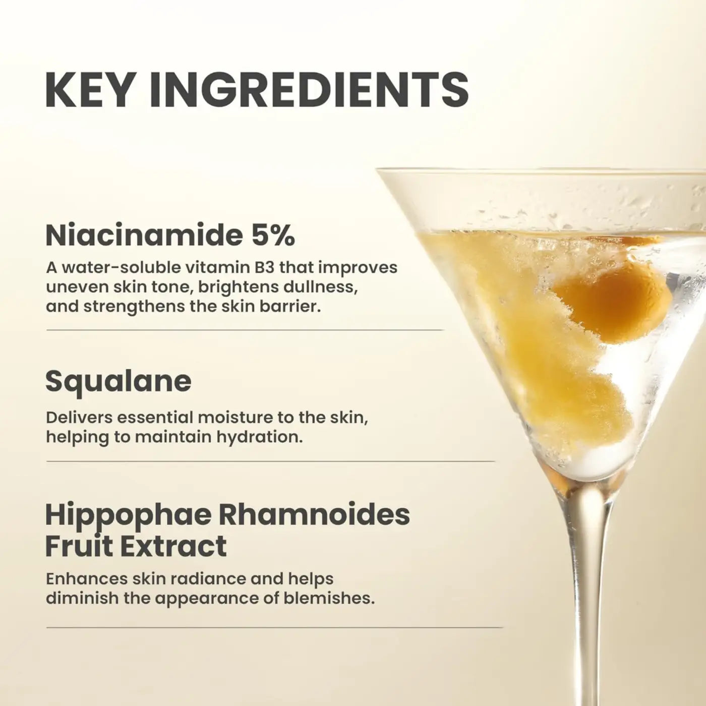 A clear martini glass filled with golden liquid and ice cubes illustrating dark spot correcting glow serum moisture barrier benefits