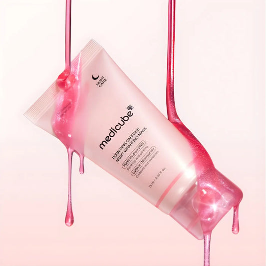 A translucent pink tube of medicube pdrn pink caffeine overnight wrapping mask 75ml with droplets on its sides