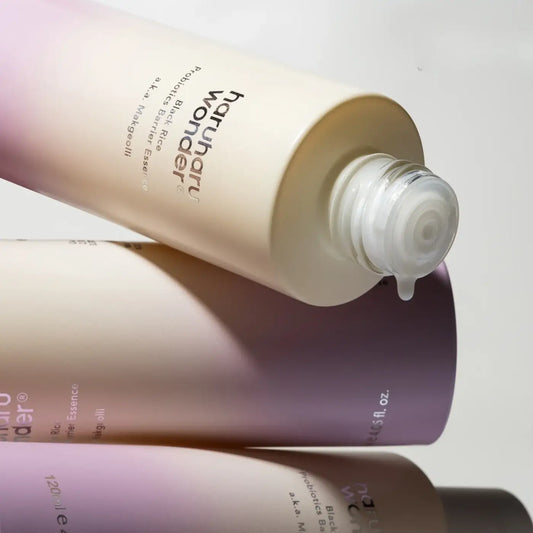 Cream-colored cylindrical bottle of haruharu probiotics barrier essence with clear pump and gradient purple-beige label, best korean skincare brands sa