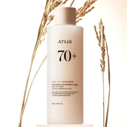 A sleek translucent white anua rice 70 glow milky toner bottle with matte pink cap for skin barrier care 250ml